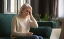 tired woman sitting on green couch