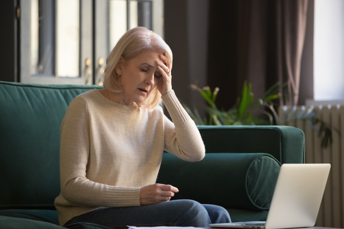 tired woman sitting on green couch