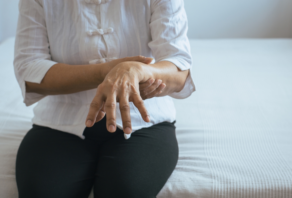 older woman holding hand