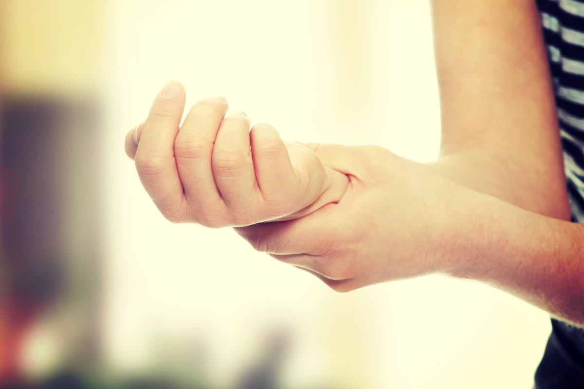 Woman holding her wrist -