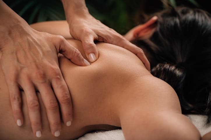Woman receiving a relaxing back massage during a spa treatment