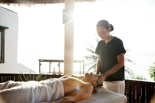 an-in-home-massage-therapist-massaging-a-client