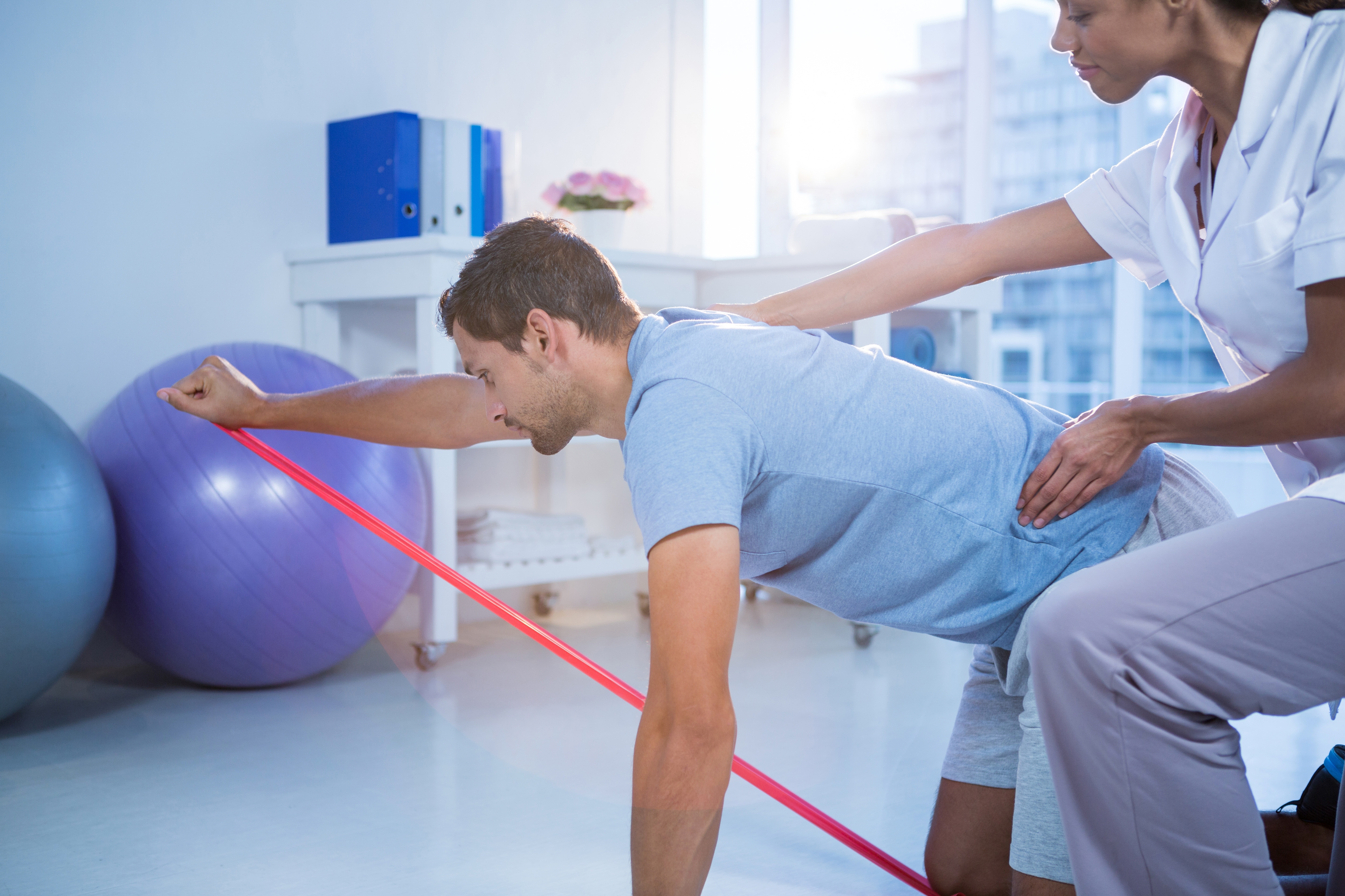an-in-home-physical-therapist-helping-a-patient-with-exercise-therapy