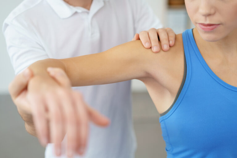 an-in-home-physical-therapist-working-on-a-patients-arm an-in-home-physical-therapist-working-on-a-patients-arm