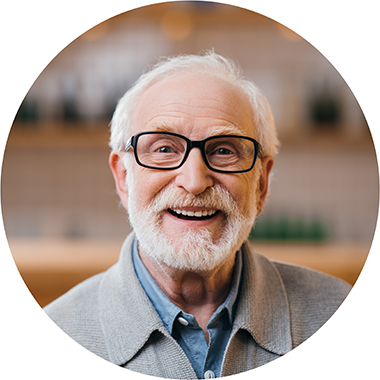 older-man-with-glasses-and-a-beard-smiling-at-the-camera