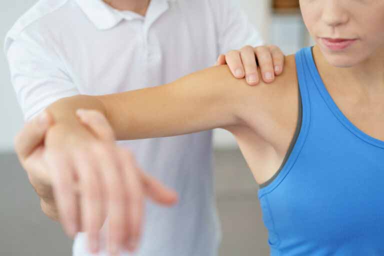 an-in-home-physical-therapist-working-on-a-patients-arm an-in-home-physical-therapist-working-on-a-patients-arm