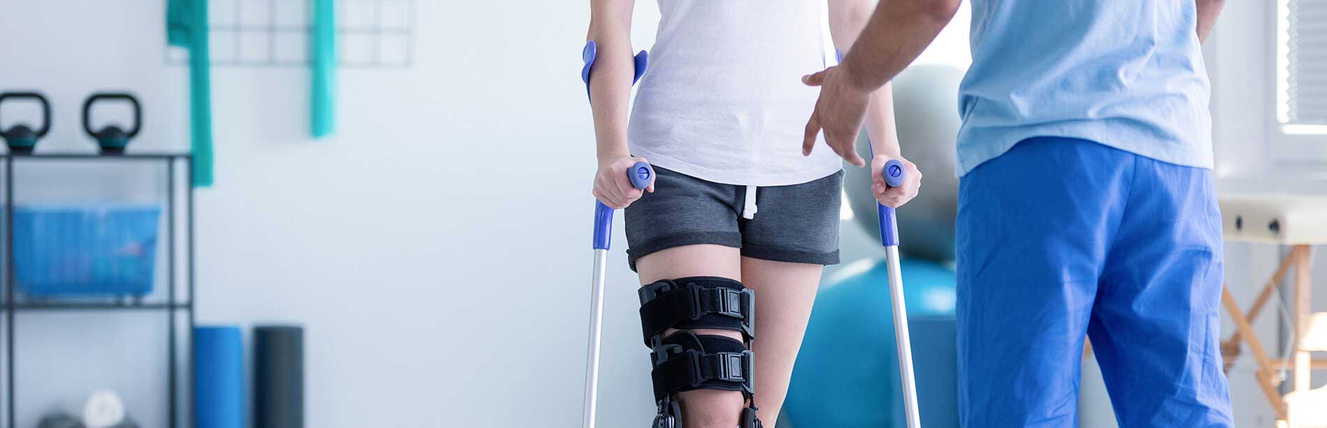 an-in-home-physio-therapist-helping-a-patient-walk-with-a-brace