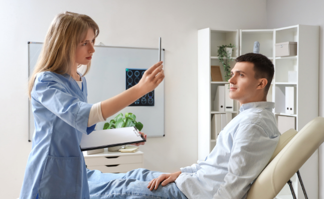 Physiotherapist performing a visual assessment as part of concussion evaluation