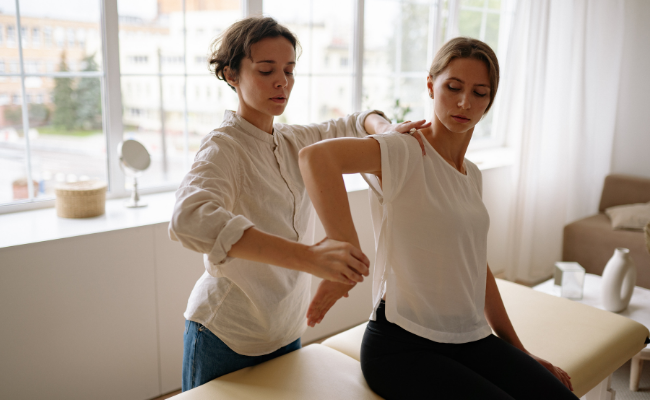 A patient receives hands-on guidance for shoulder movement as part of mobile physiotherapy in Edmonton