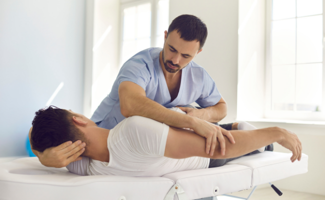 Hands-on upper-body treatment provided during a mobile physiotherapy visit in Surrey