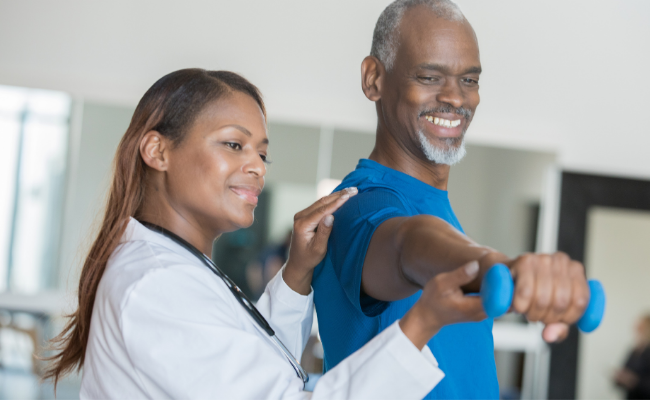A patient performs supported arm strengthening as part of neurological physiotherapy in Vancouver
