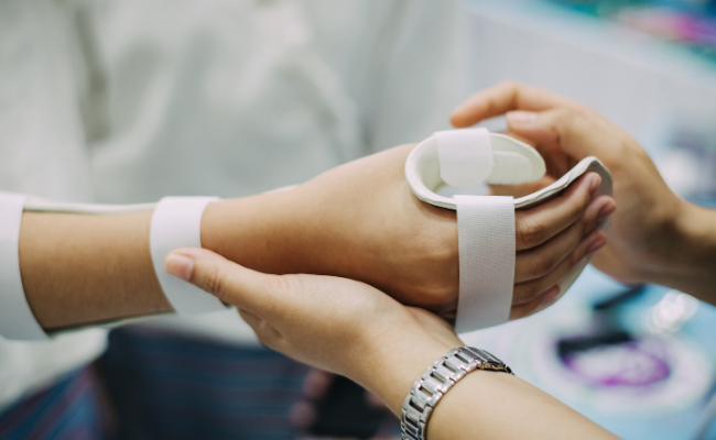 Post-surgery elbow support being applied during physiotherapy care in Edmonton