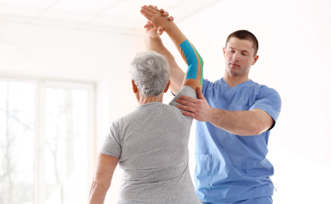 Guided overhead arm movement used in seniors physiotherapy sessions in Vancouver